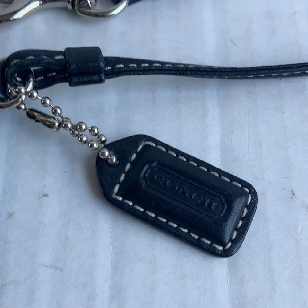 Coach black signature C mini wristlet.